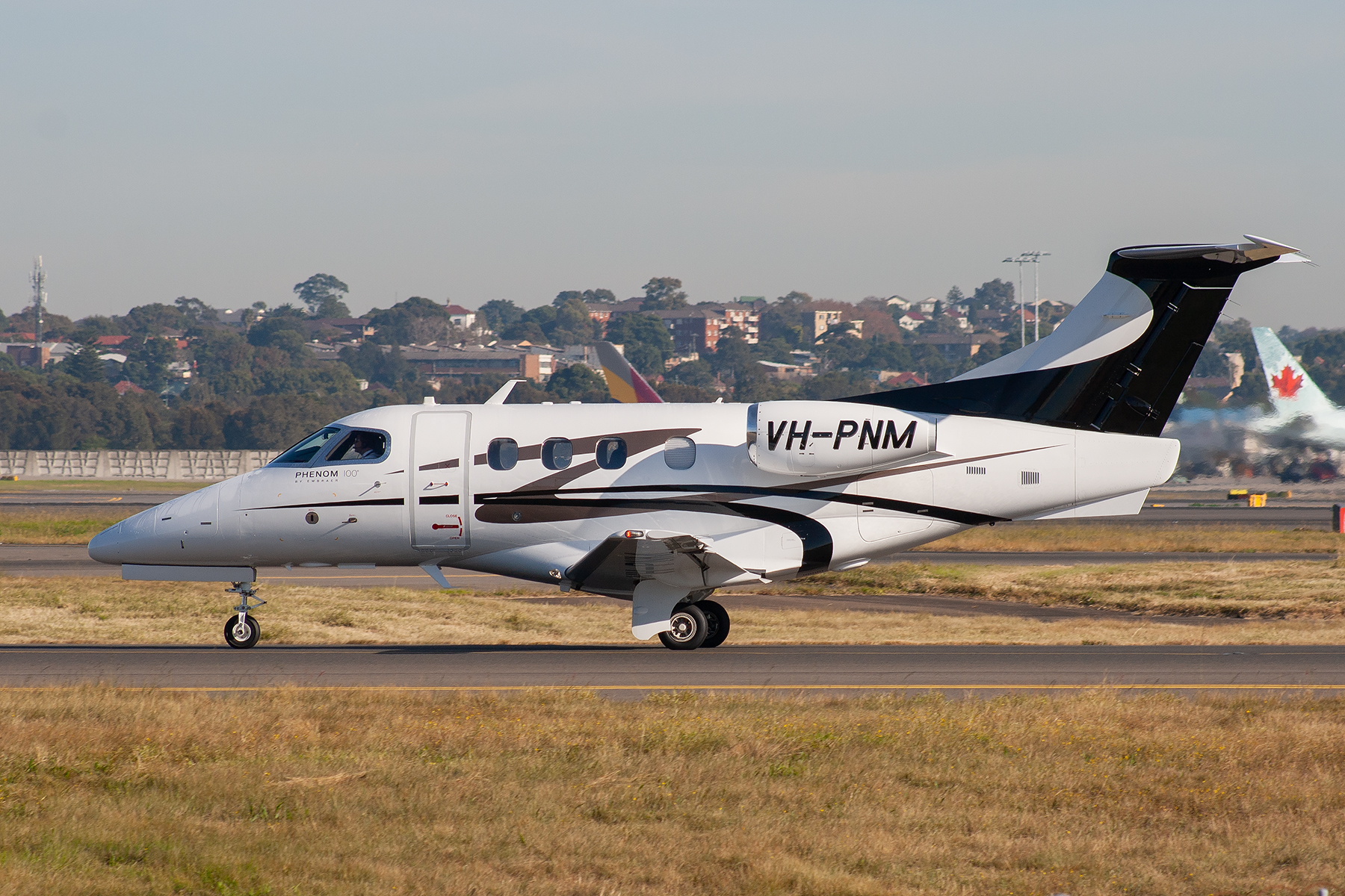 GoJet (Pty) Embraer Embraer Phenom 100 VH-PNM at Kingsford Smith